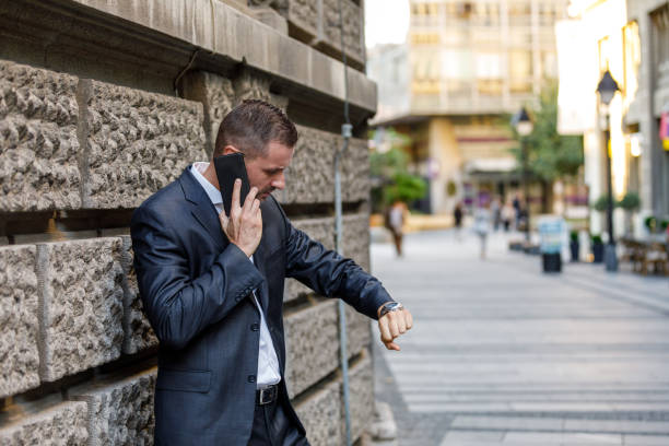 istock A Young Businessman in Hurry to Going to the Office and Using a Mobile Phone While Walking in City Street. 1464766951