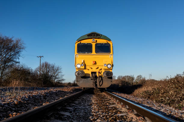 Front view of an approaching  freight locomotive on railway tracks A low angle front point of view of a freight locomotive engine approaching a trespasser on a railway line in an industrial safety image with copy space train vehicle front view stock pictures, royalty-free photos & images