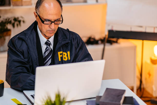 istock FBI Detective Using Laptop In His Office 1464768465