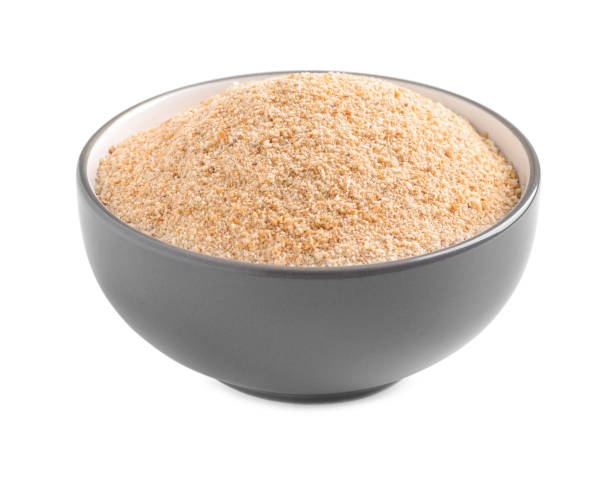 istock Fresh bread crumbs in bowl isolated on white 1464770112
