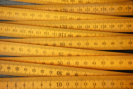 Traditional yellow wooden folding rule with decimal metric system