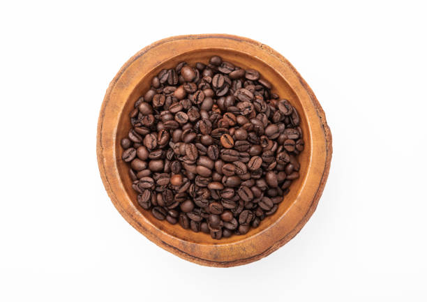 istock Raw coffee beans in wooden bowl plate on white background. 1464771337