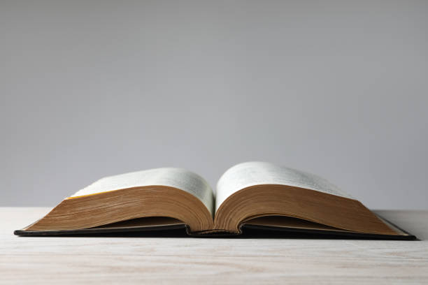 istock Open Bible on wooden table. Christian religious book 1464771463