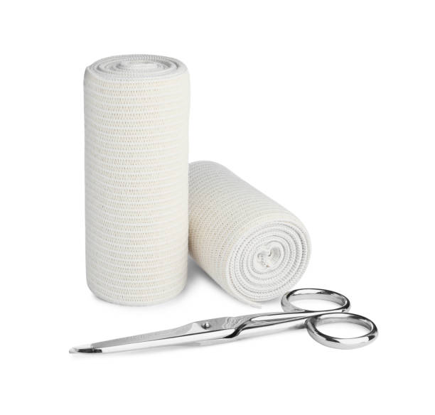 istock Medical bandage rolls and scissors on white background 1464772430