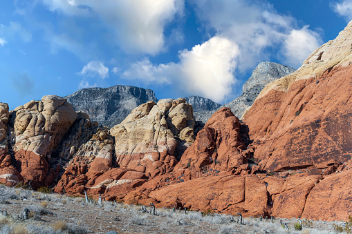 Landscape of rock formations in Red Rock Canyon in Nevada with cloudy blue sky