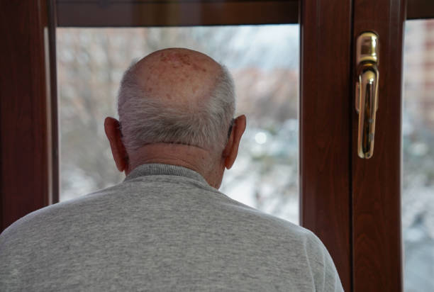 istock Old man looking at the window. loneliness in elderly 1464773908