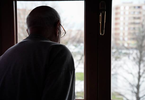 istock caucasian mature man looking at the window. loneliness in elderly 1464773932