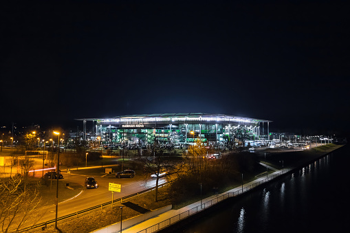 Wolfsburg, Germany - March 2022: Night view of the illuminated Volkswagen Arena stadium after VfL Wolfsburg Bundesliga match.