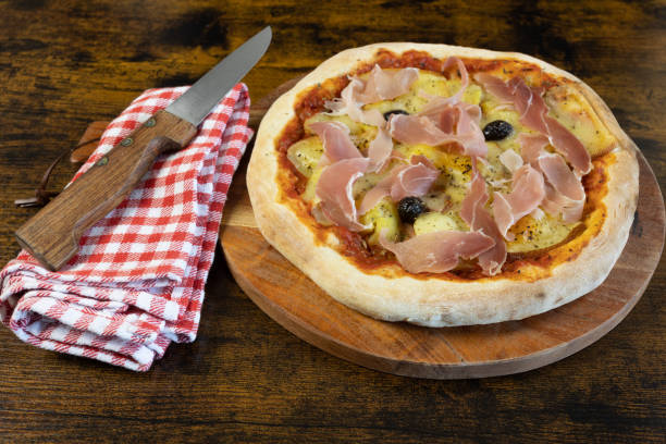 istock pizza ham, raclette cheese and potatoes on a cutting board 1464775984