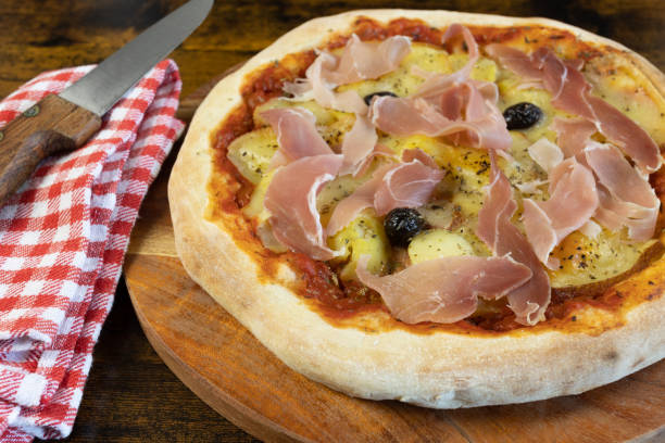 istock pizza ham, raclette cheese and potatoes on a cutting board 1464775985