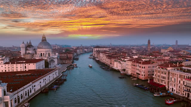 4K aerial drone view of Venice grand canal cathedral church in old town birds view. Venice italy skyline at sunset colored sky. Italy