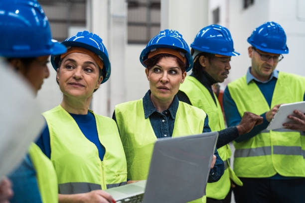 istock Team of diverse engineers working in robotic factory - Tech industrial concept 1464781302