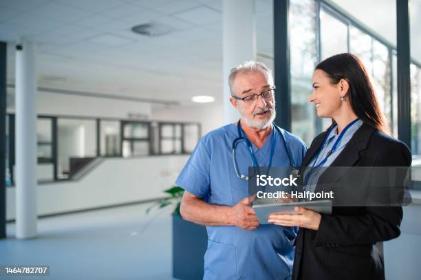 Young Business Woman Shaking Hand With Elderly Doctor Stock Photo - Download Image Now