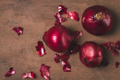 Red onion, fresh, raw, on a dark background, top view,