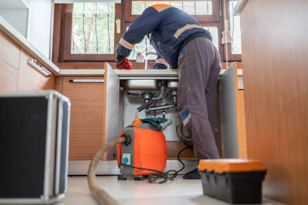 Plumber Unclogging A Kitchen Sink Drain Plumber Unclogging A Kitchen Sink Drain With Pipe Cleaning Machine sewer drain stock pictures, royalty-free photos & images