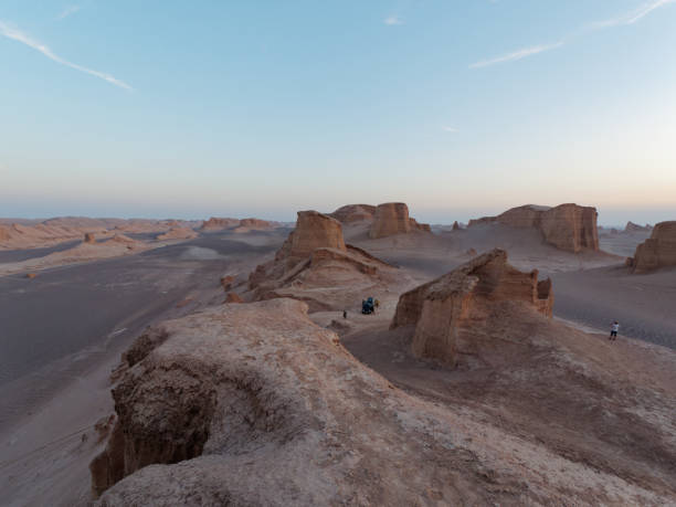 istock Peaceful view of the beautiful Dasht-e Lut Desert and its rock formations (Kaluts) at sunset, Kerman Province, Iran 1464786825