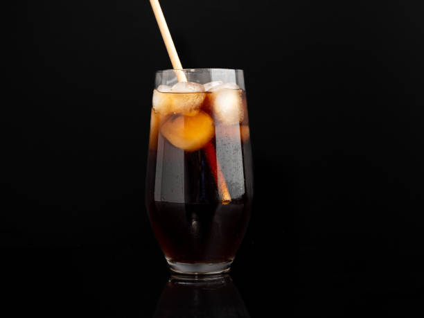 istock Glass of cola with ice on a black background. 1464786963