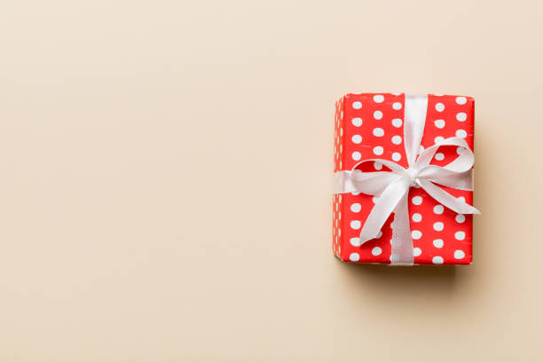 istock Valentine day composition: red gift box with bow and heart. Christmas present. View from above. Space for text. Holday greeting card 1464787248