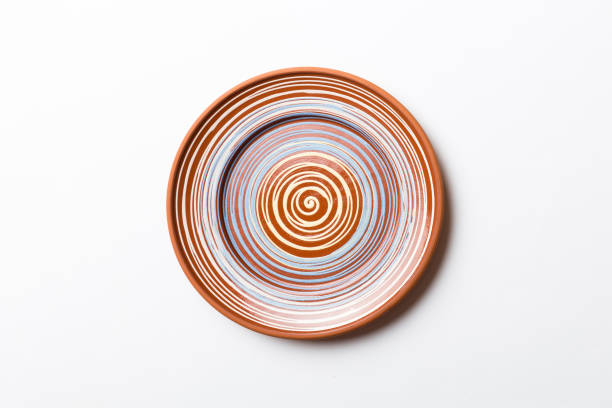 top view of isolated of colored background empty round brown plate for food. empty dish with space for your design - plate ceramics pottery isolated imagens e fotografias de stock