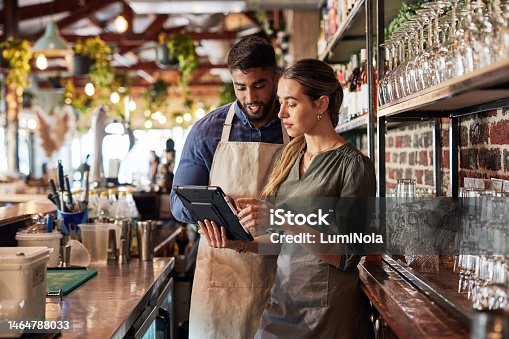 istock Tablet, bartender or small business people for communication, networking or online order check. Research, planning startup or teamwork for inventory checklist, stock management or social media review 1464788033