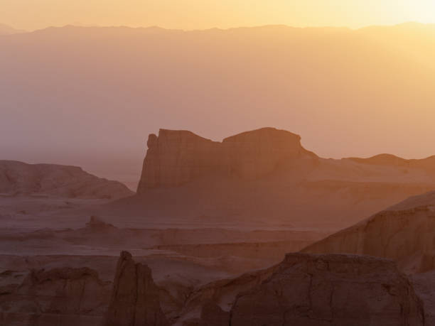 istock Peaceful view of the beautiful Dasht-e Lut Desert and its rock formations (Kaluts) at sunset, Kerman Province, Iran 1464788817
