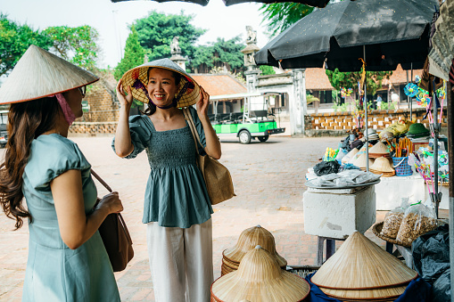two female Traveler while shopping at vietnamese street market \n\nVietnam and Southeast Asia travel concept\nHanoi, Vietnam