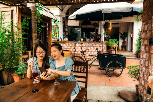 istock two young vietnamese friends hanging out at cafe 1464789172