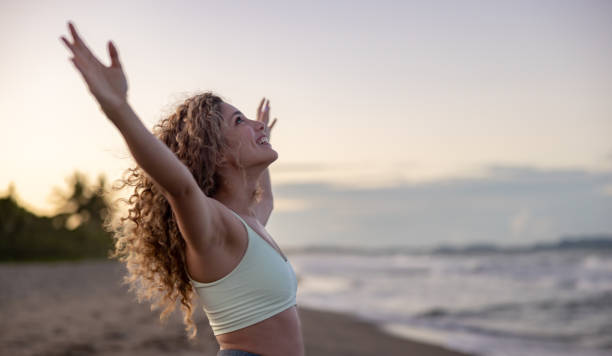 istock Excited woman enjoying her time at the beach 1464792303