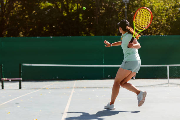 istock Woman playing tennis 1464793175