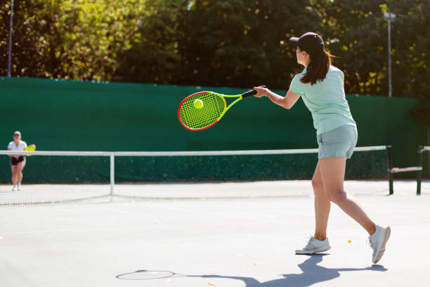 istock Woman playing tennis 1464793192
