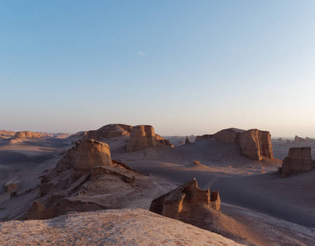 istock Peaceful view of the beautiful Dasht-e Lut Desert and its rock formations (Kaluts) at sunset, Kerman Province, Iran 1464794528