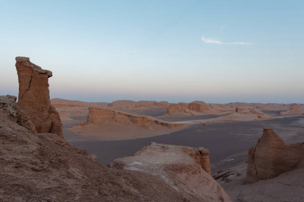 istock Peaceful view of the beautiful Dasht-e Lut Desert and its rock formations (Kaluts) at sunset, Kerman Province, Iran 1464794588
