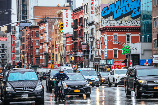 Busy traffic on the streets of rainy Chinatown in New York City, NY, USA