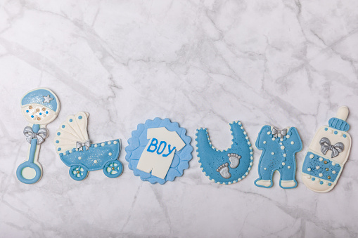 Baby shower cookies on a white marble background. Delicious cookies for a baby party. Baby shower party concept. Flat lay. View from above. candy bar