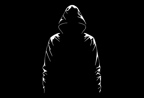 Silhouette of anonymous on a black background. Mysterious man in a hood