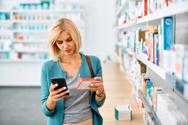 istock Woman using app on mobile phone while shopping in a pharmacy, 1464802640