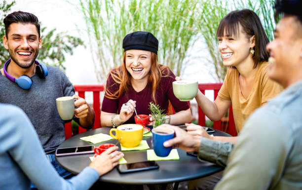 istock Diverse people group drinking latte at coffee bar garden - Happy friends talking and having fun together at hostel dehors - Life style concept with young men and women at cafe venue - Bright filter 1464804752