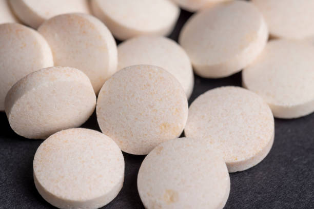 istock White and yellow medical medicines on a black background 1464805883