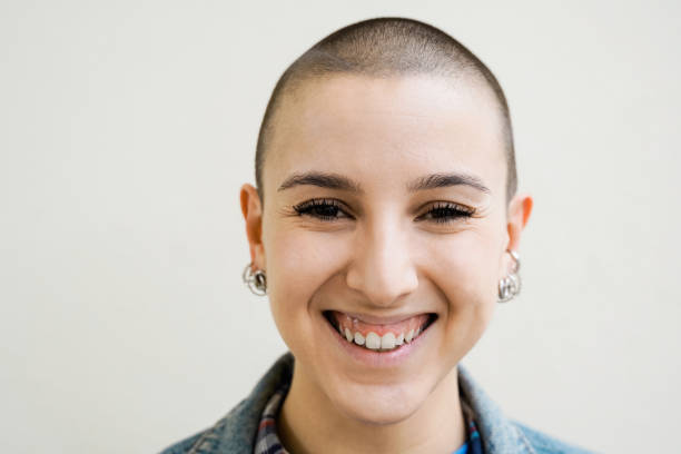 istock Happy bald young woman smiling on camera outdoors - Diversity, androgynous concept - Focus on face 1464813485