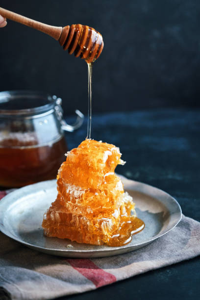 Healthy Honey Slow Dripping from  Honeycombs stock photo