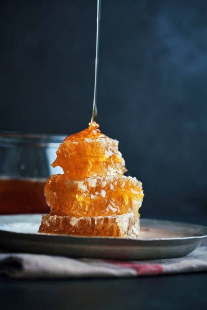 istock Healthy Honey Slow Dripping from  Honeycombs 1464814718