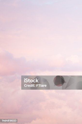istock Sky with soft and fluffy pastel pink and blue colored clouds. Sunset background. Nature. sunrise. Instagram toned style. Vertical 1464818033