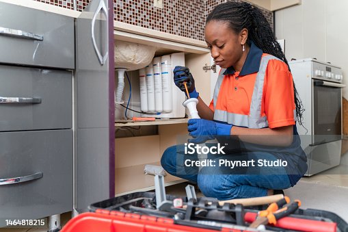istock Black female plumber at work 1464818215