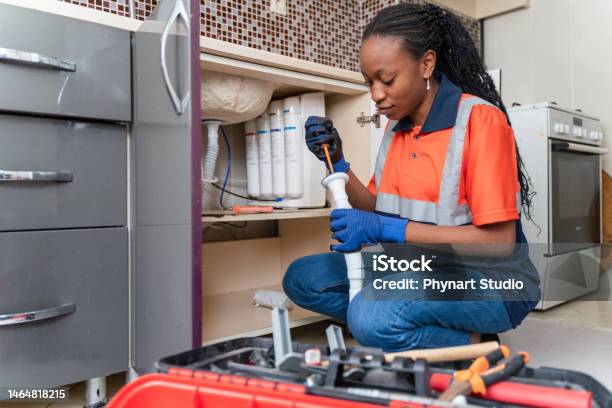 Black Female Plumber At Work Stock Photo - Download Image Now - Plumber, Water Pipe, Kitchen Sink