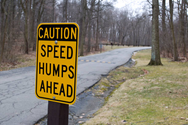 istock Caution speed hump road warning sign in public park 1464819639