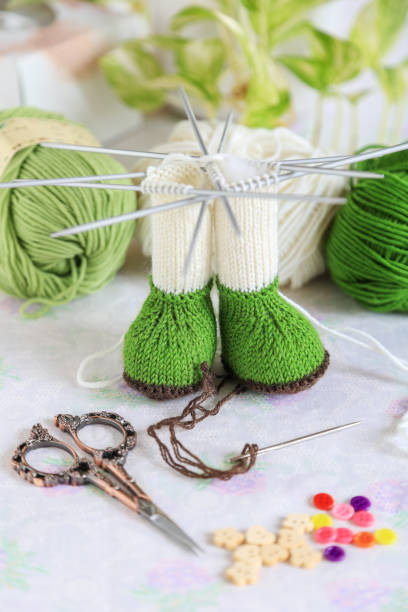 istock Working table with knitted animal toy body part with knitting tools 1464826021