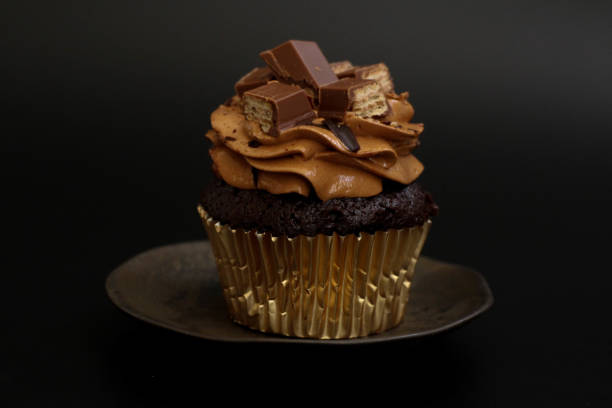 istock Close up Chocolate Cup Cake on Black background 1464828109