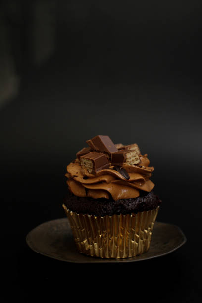 istock Close up Chocolate Cup Cake on Black background 1464828121