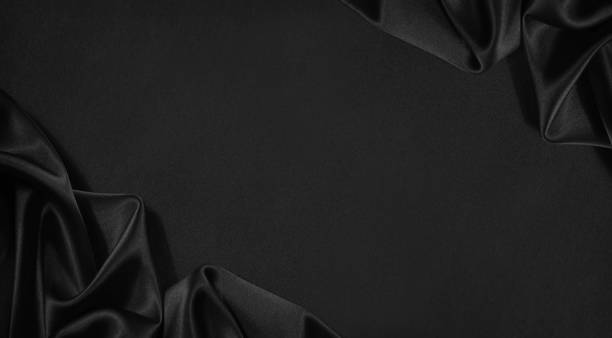 Black silk satin.  Elegant fabric background with space. Table top view.