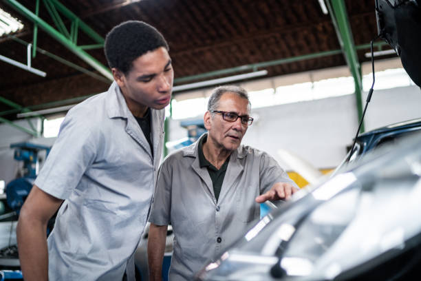 istock Auto mechanics analyzing the car engine on the repair shop 1464834284